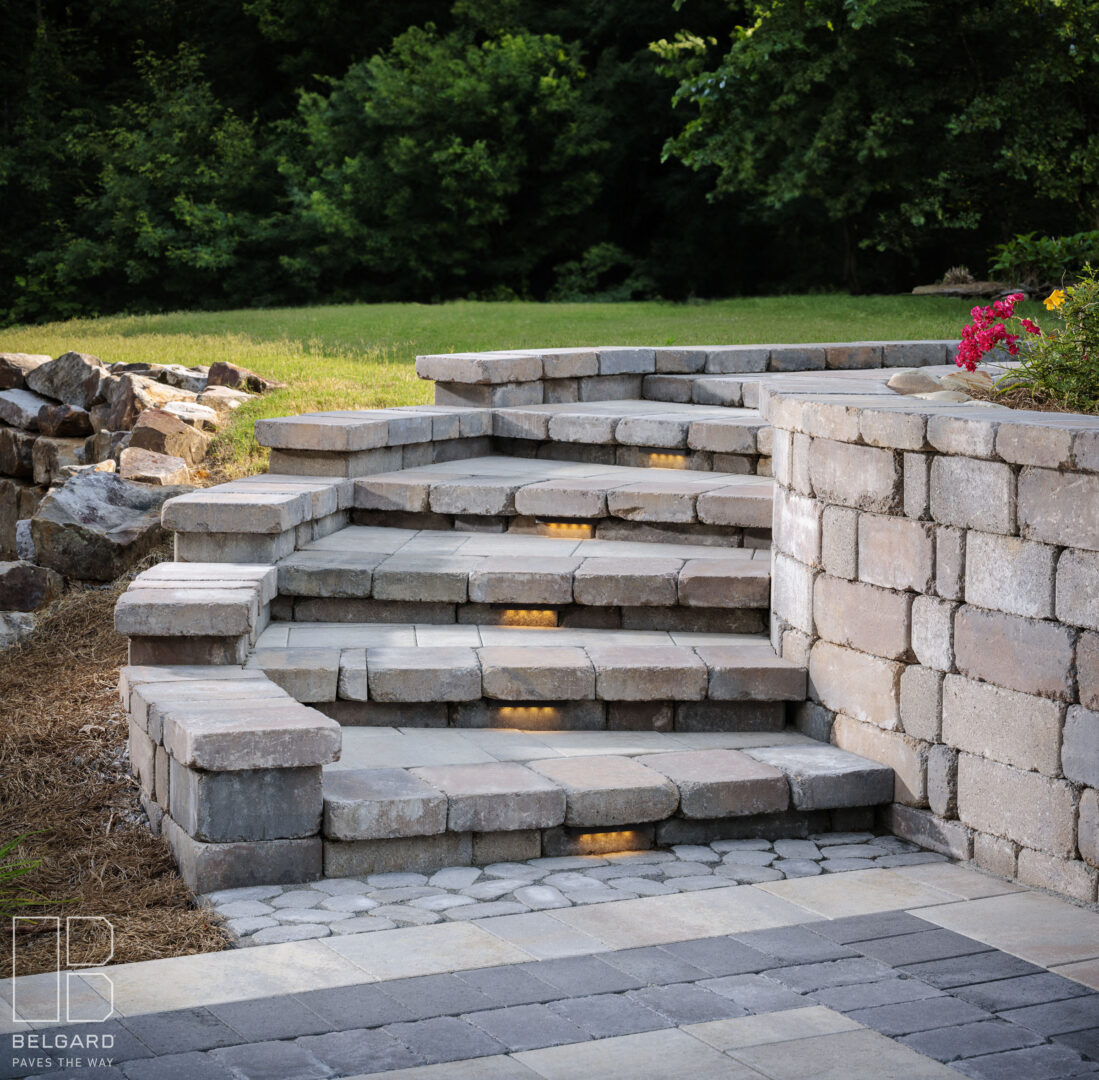 Stone steps with built-in lights in a landscaped garden.
