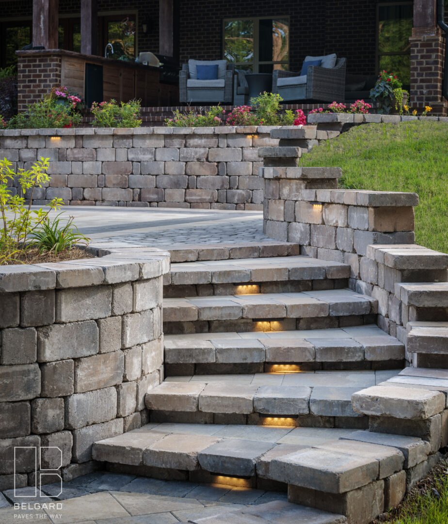 Stone stairs with built-in lights leading to a cozy patio.